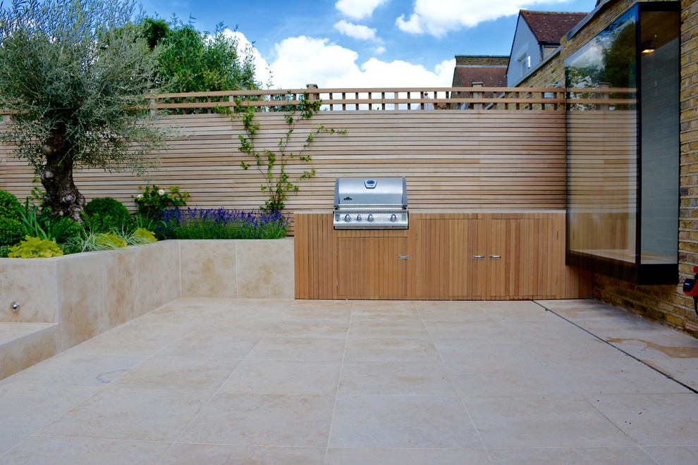 Inspiration for a medium sized contemporary back full sun garden for summer in London with natural stone paving.