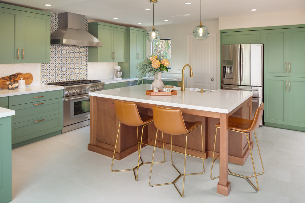 Inspiration for a large transitional l-shaped eat-in kitchen remodel in San Diego with recessed-panel cabinets, green cabinets, multicolored backsplash, stainless steel appliances and white countertops