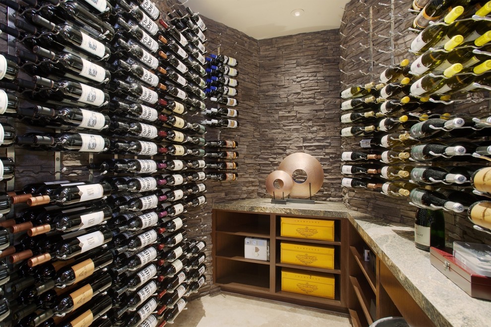Contemporary wine cellar in Los Angeles with display racks and beige floor.