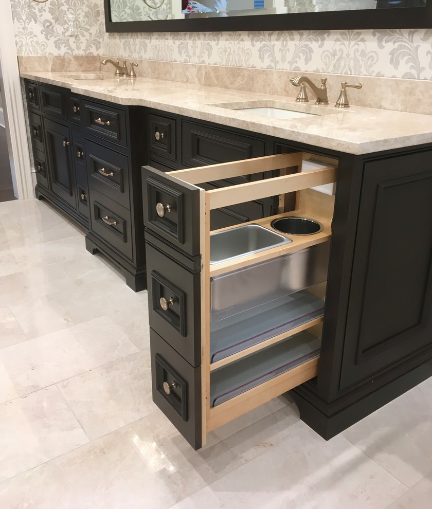 Example of a large transitional master beige tile and marble tile marble floor and beige floor freestanding bathtub design in Kansas City with raised-panel cabinets, dark wood cabinets, a two-piece toilet, beige walls, a drop-in sink, marble countertops, a hinged shower door and beige countertops