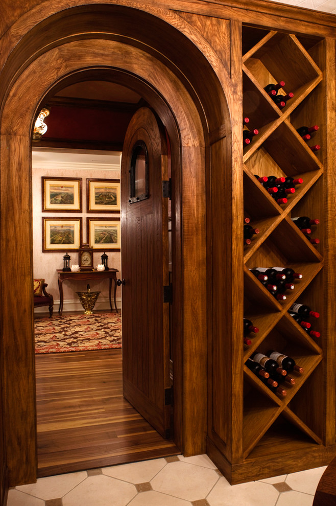 Design ideas for a large beach style wine cellar in New York with limestone floors and diamond bins.