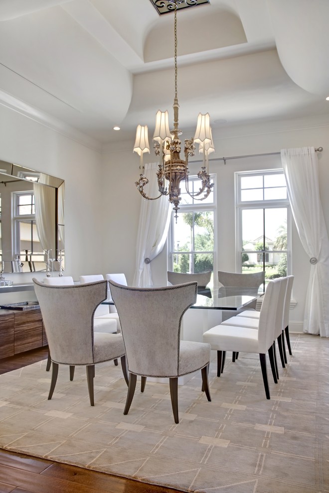 Design ideas for a transitional dining room in Orlando with white walls and dark hardwood floors.