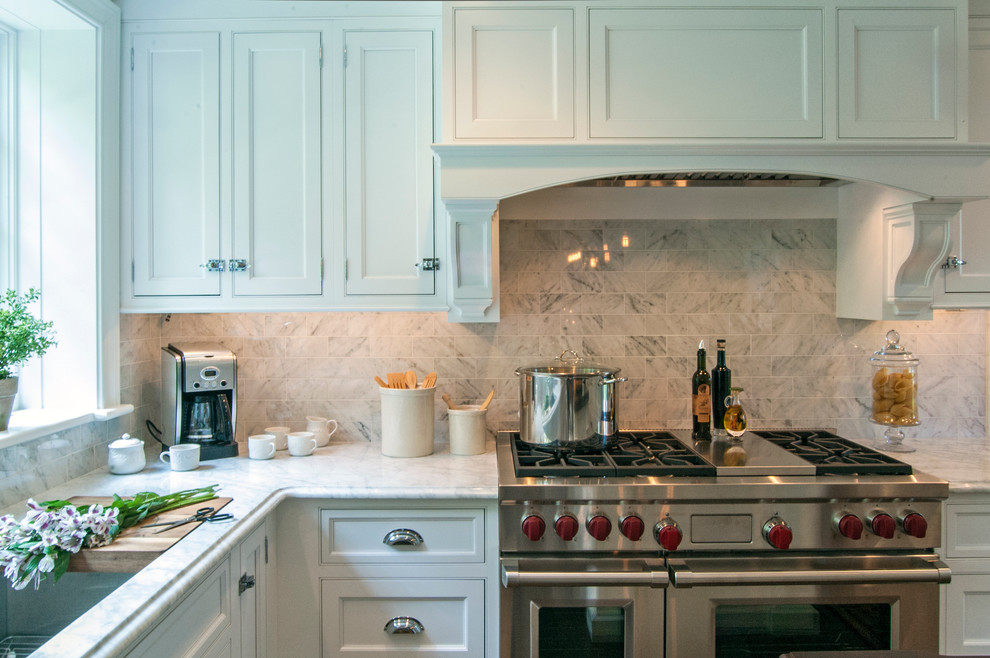 Inspiration for a large traditional l-shaped eat-in kitchen in Philadelphia with an undermount sink, flat-panel cabinets, white cabinets, wood benchtops, white splashback, stone tile splashback, stainless steel appliances, dark hardwood floors and with island.