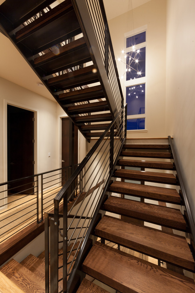 Photo of a mid-sized modern wood u-shaped staircase in Denver with open risers.