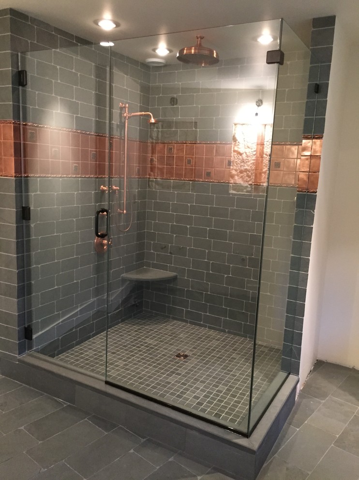 This is an example of a large country master bathroom in Philadelphia with a freestanding tub, a corner shower, black tile, stone tile, black walls and slate floors.