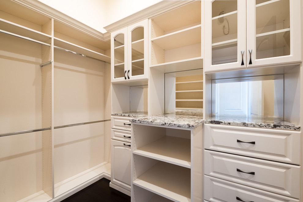 Large transitional women's walk-in wardrobe in Orlando with raised-panel cabinets, white cabinets and dark hardwood floors.