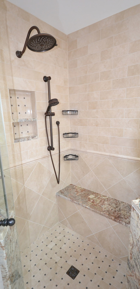 Photo of a large transitional master bathroom in Philadelphia with recessed-panel cabinets, dark wood cabinets, a drop-in tub, a corner shower, a one-piece toilet, beige tile, ceramic tile, pink walls, ceramic floors, an undermount sink, granite benchtops, beige floor, a hinged shower door, multi-coloured benchtops, a shower seat, a double vanity, a built-in vanity and vaulted.