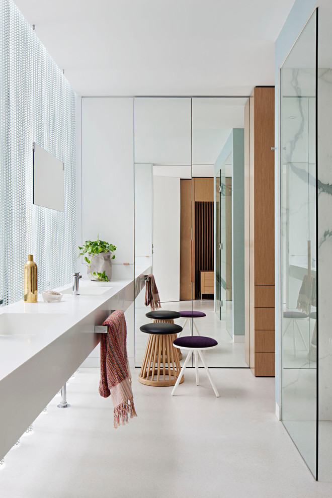 This is an example of a contemporary master bathroom in Melbourne with a curbless shower, an integrated sink, white floor and white benchtops.