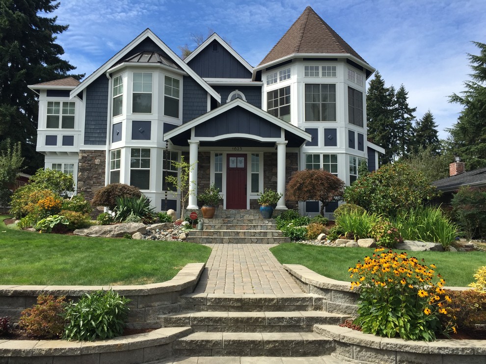 Photo of a mid-sized traditional three-storey grey exterior in Seattle with wood siding.