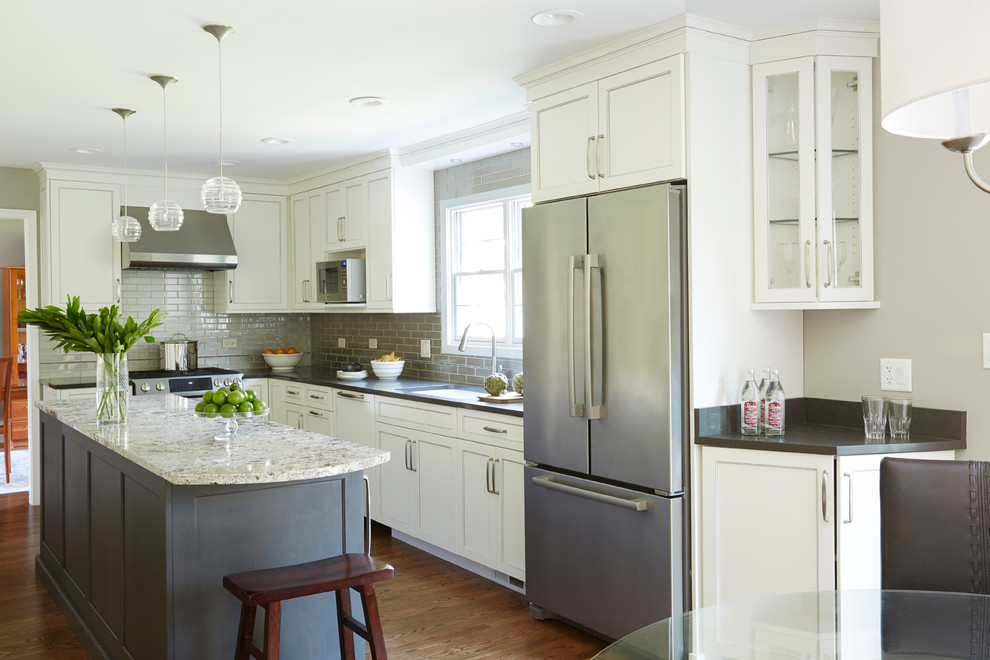 Inspiration for a mid-sized transitional galley eat-in kitchen in Chicago with white cabinets, quartz benchtops, grey splashback, stainless steel appliances, medium hardwood floors, with island, an undermount sink, recessed-panel cabinets and glass tile splashback.
