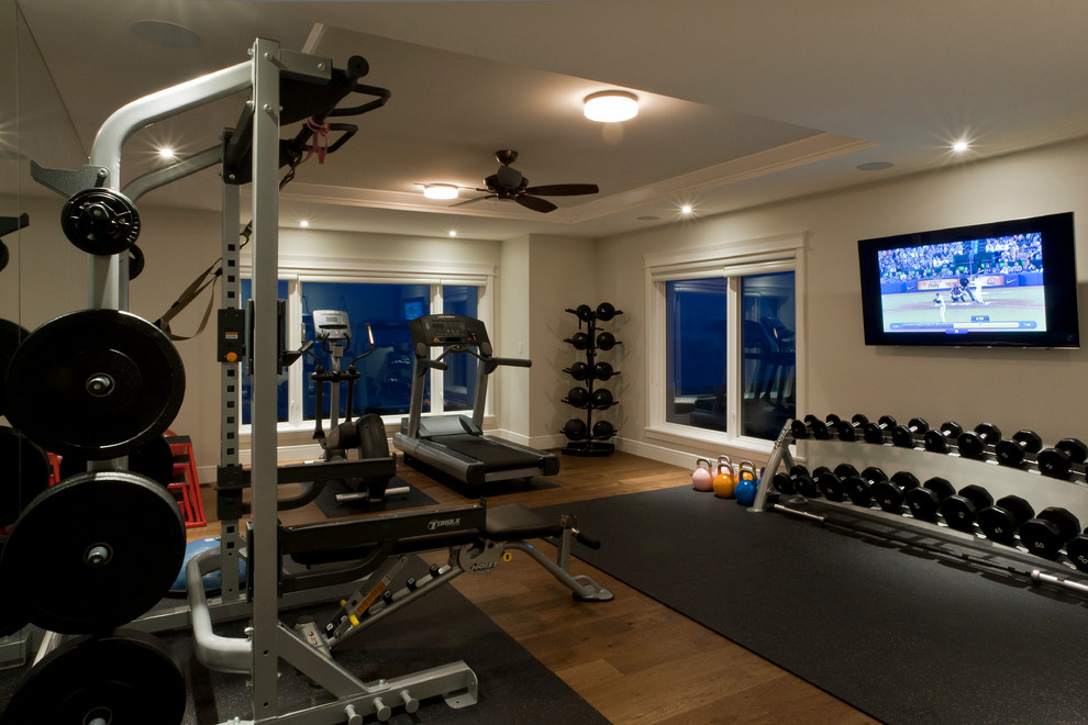 Design ideas for a mid-sized contemporary multipurpose gym in Vancouver with grey walls and medium hardwood floors.