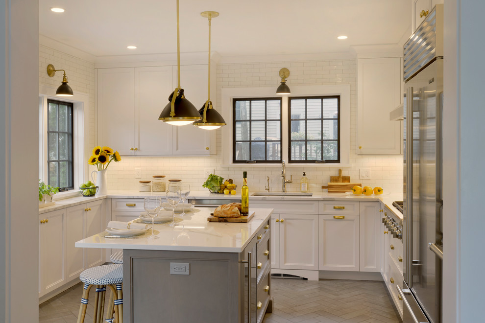 Inspiration for a small transitional u-shaped porcelain tile and gray floor enclosed kitchen remodel in New York with an undermount sink, recessed-panel cabinets, white cabinets, quartz countertops, white backsplash, ceramic backsplash, stainless steel appliances, an island and white countertops