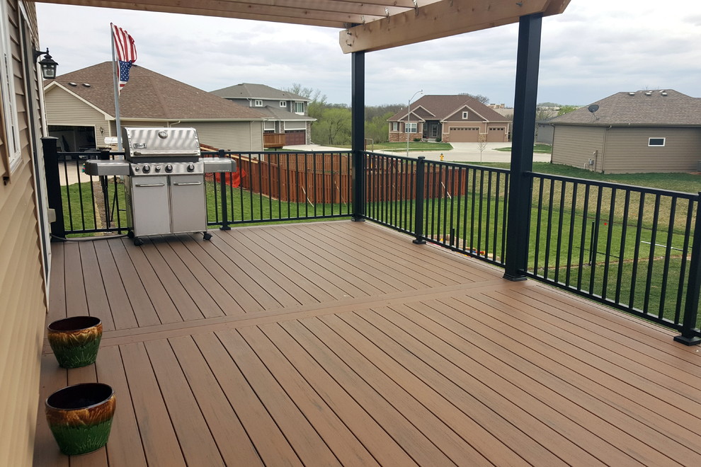 Example of a large backyard deck design with a pergola