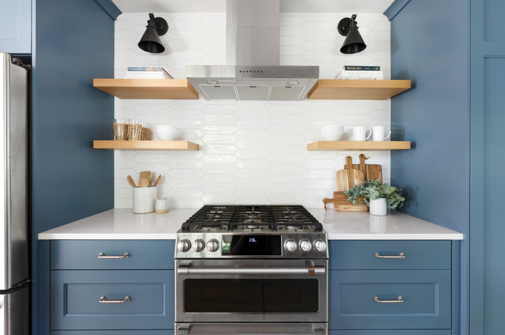 Design ideas for a mid-sized transitional galley eat-in kitchen in Portland with an undermount sink, recessed-panel cabinets, blue cabinets, quartz benchtops, white splashback, cement tile splashback, stainless steel appliances, light hardwood floors, no island and white benchtop.