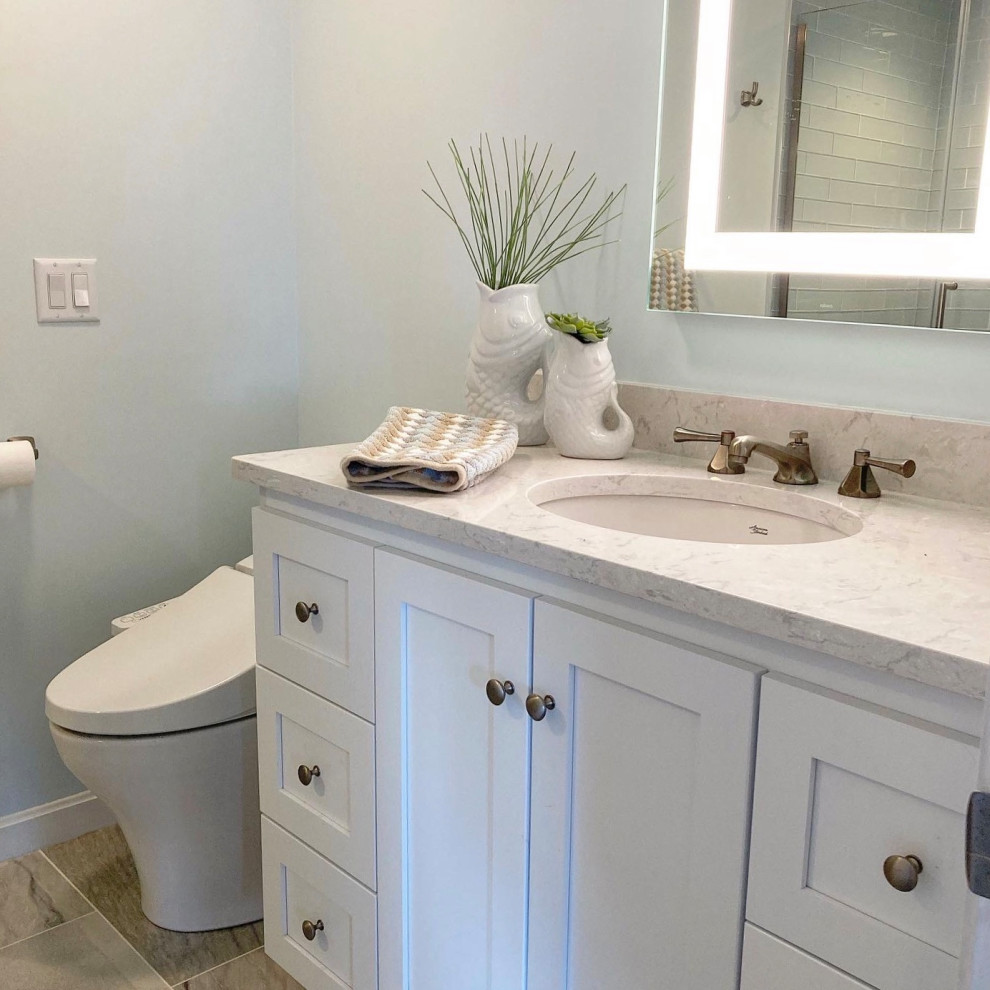 This is an example of a medium sized coastal bathroom in Boston with shaker cabinets, white cabinets, an alcove shower, a bidet, blue tiles, glass tiles, blue walls, a submerged sink, engineered stone worktops, a hinged door, blue worktops, a single sink and a freestanding vanity unit.