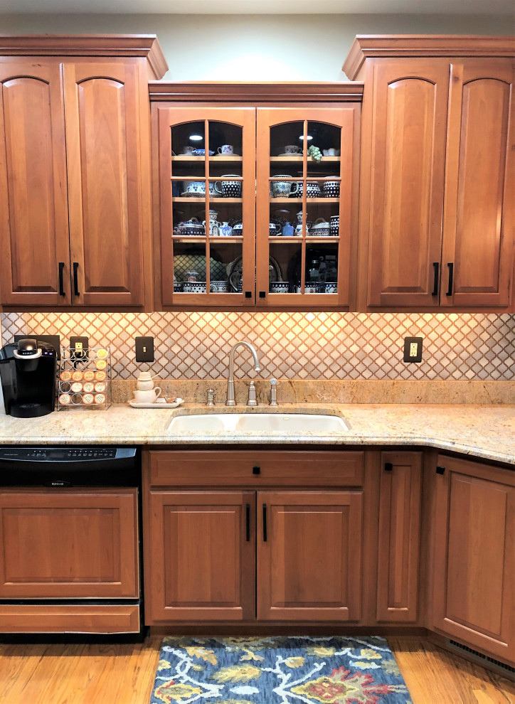 Photo of a mid-sized traditional kitchen in Baltimore with raised-panel cabinets, granite benchtops and beige benchtop.