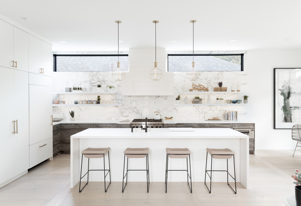 Inspiration for a large scandinavian l-shaped open plan kitchen in Toronto with an undermount sink, flat-panel cabinets, distressed cabinets, quartz benchtops, white splashback, marble splashback, panelled appliances, light hardwood floors, with island, white floor and white benchtop.