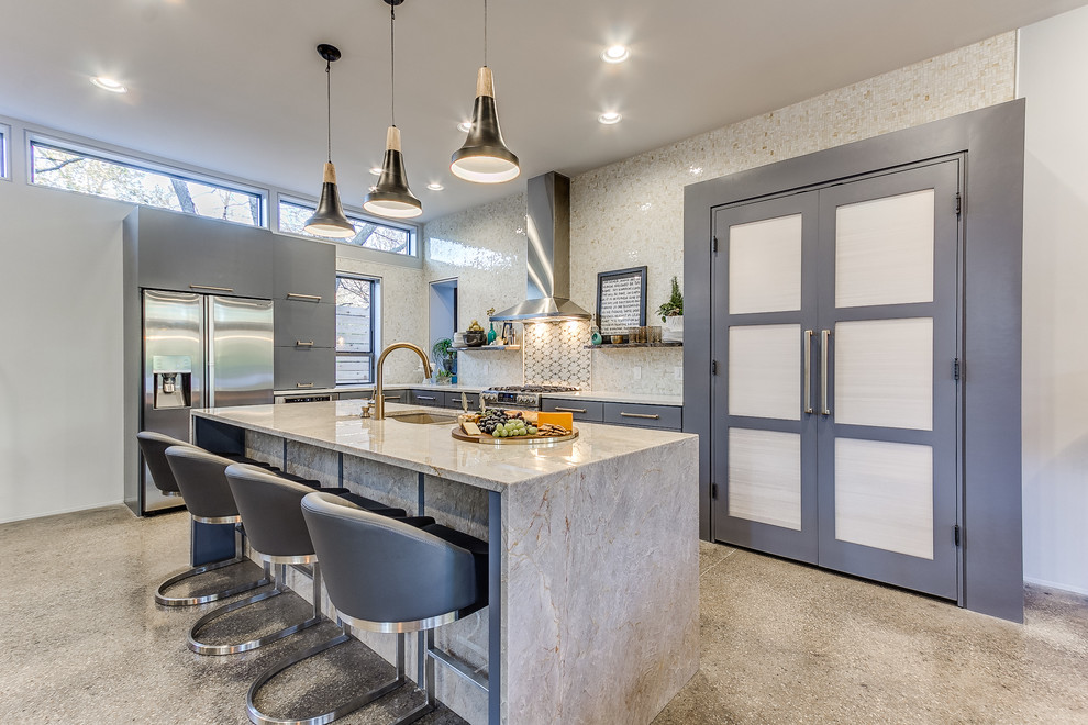 This is an example of a contemporary l-shaped kitchen in Oklahoma City with stainless steel appliances, with island, an undermount sink, flat-panel cabinets, grey cabinets, white splashback and concrete floors.