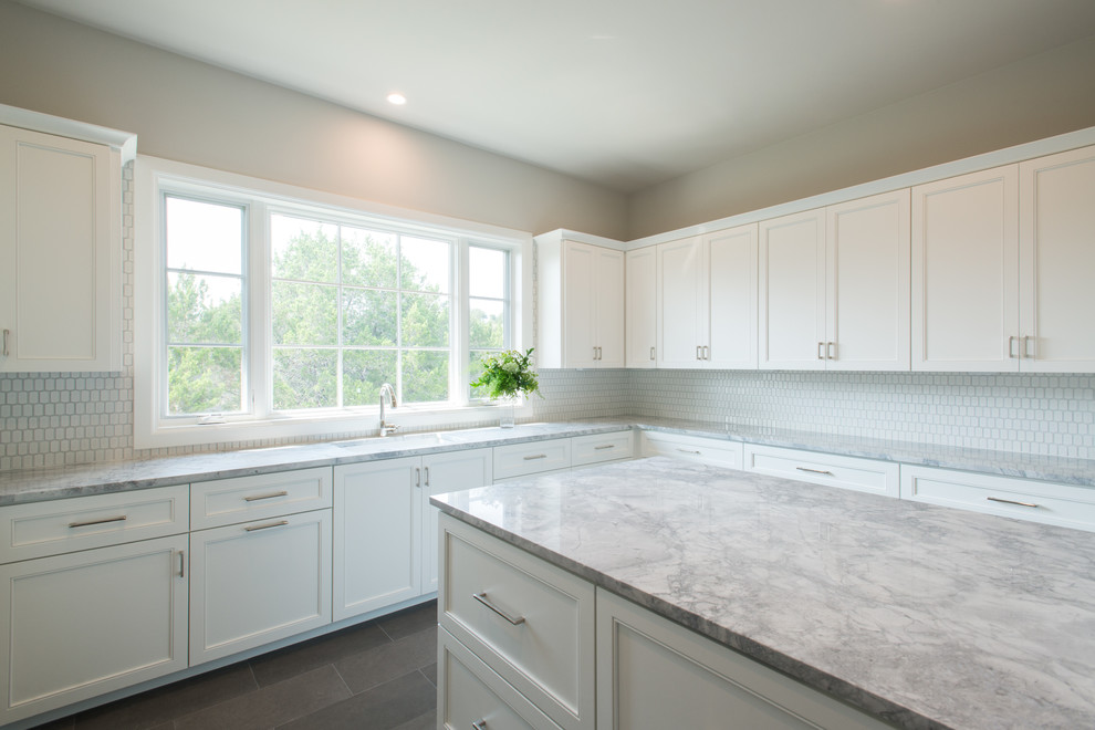 Inspiration for an expansive transitional u-shaped utility room in Austin with an undermount sink, flat-panel cabinets, white cabinets, marble benchtops, grey walls and a side-by-side washer and dryer.