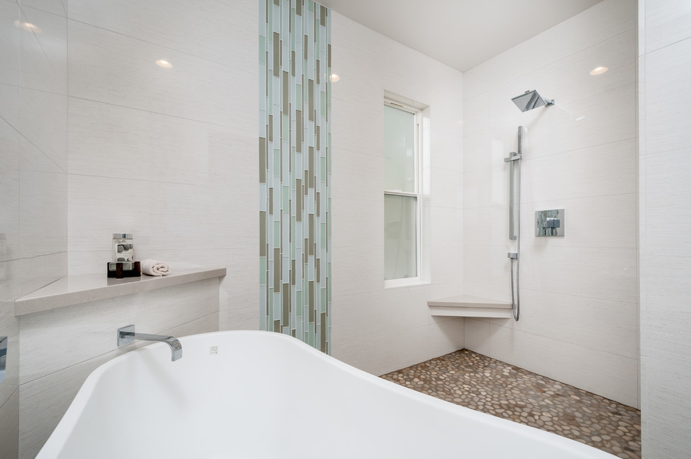 This is an example of a large contemporary master bathroom in San Francisco with shaker cabinets, grey cabinets, a freestanding tub, an open shower, a one-piece toilet, beige tile, porcelain tile, beige walls, pebble tile floors, an undermount sink and engineered quartz benchtops.