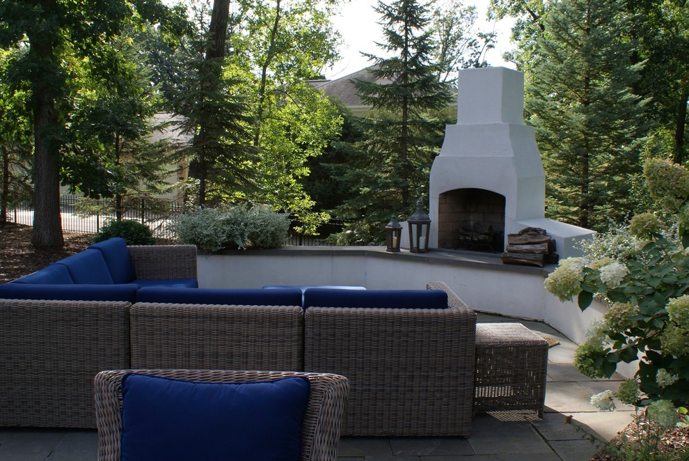 Inspiration for a large traditional backyard patio in Minneapolis with natural stone pavers and no cover.