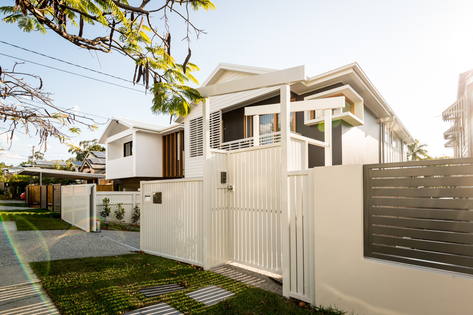 Design ideas for a scandinavian two-storey grey exterior in Brisbane with wood siding.