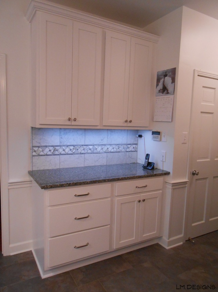 Inspiration for a transitional porcelain tile eat-in kitchen remodel with shaker cabinets, white cabinets, granite countertops, stone tile backsplash and no island