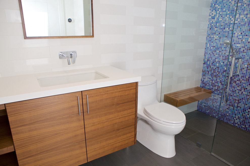 Walk-in shower - large modern master multicolored tile and mosaic tile ceramic tile and gray floor walk-in shower idea in San Francisco with flat-panel cabinets, dark wood cabinets, a one-piece toilet, white walls, an undermount sink, quartz countertops and a hinged shower door