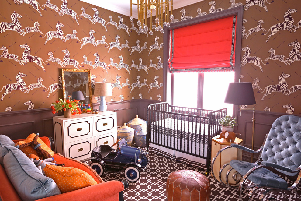 This is an example of an eclectic nursery for boys in Chicago with brown walls and carpet.