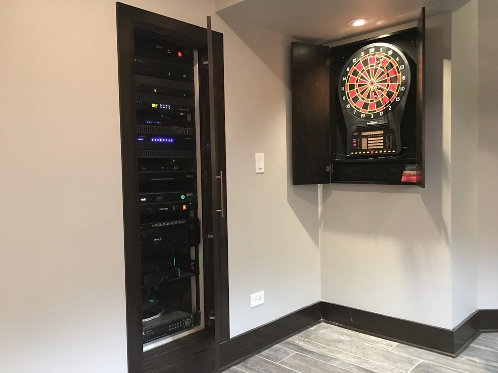 Inspiration for a mid-sized transitional underground dark wood floor and brown floor basement remodel in Chicago with beige walls and no fireplace