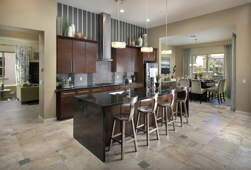 This is an example of a mid-sized transitional single-wall eat-in kitchen in Austin with an undermount sink, flat-panel cabinets, dark wood cabinets, quartz benchtops, multi-coloured splashback, mosaic tile splashback, stainless steel appliances, porcelain floors, with island and brown floor.