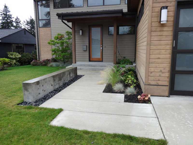 This is an example of a small traditional full sun front yard concrete paver landscaping in Seattle for summer.