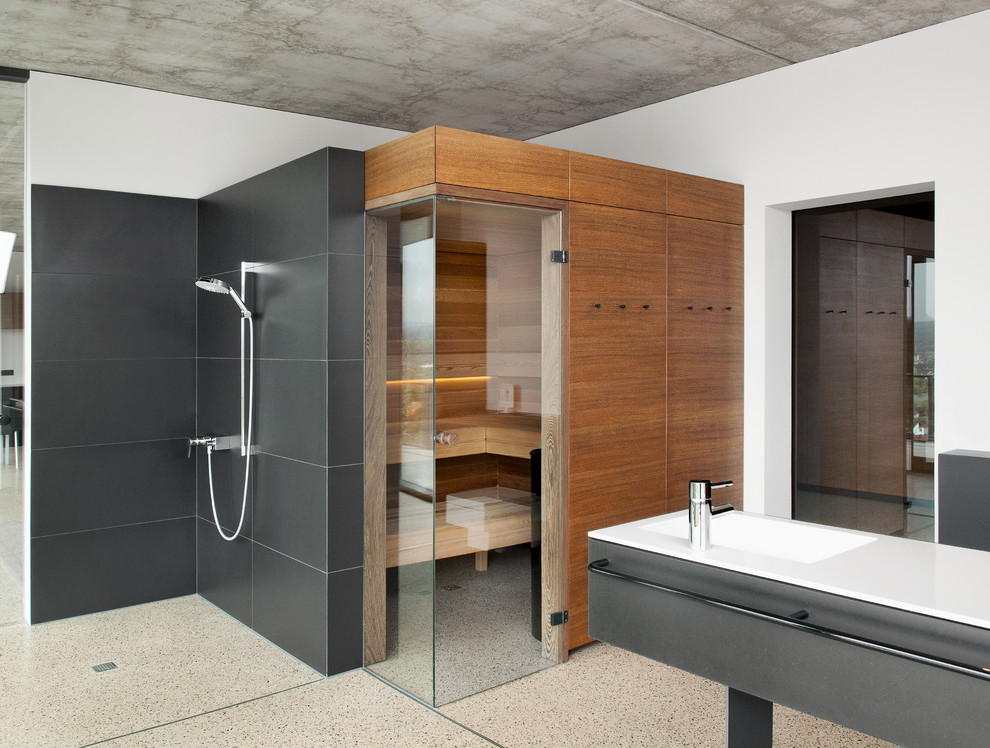 Photo of a mid-sized modern bathroom in Other with flat-panel cabinets, brown cabinets, a curbless shower, white walls, a console sink, multi-coloured floor, a hinged shower door and with a sauna.