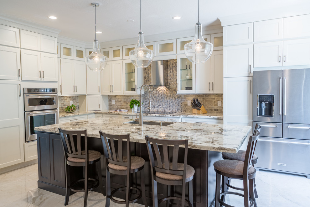 Inspiration for a large transitional l-shaped open concept kitchen remodel in Miami with an undermount sink, flat-panel cabinets, white cabinets, quartzite countertops, multicolored backsplash and an island