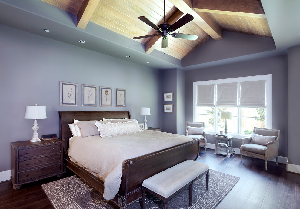 This is an example of an expansive traditional master bedroom in Houston with grey walls, dark hardwood floors and brown floor.