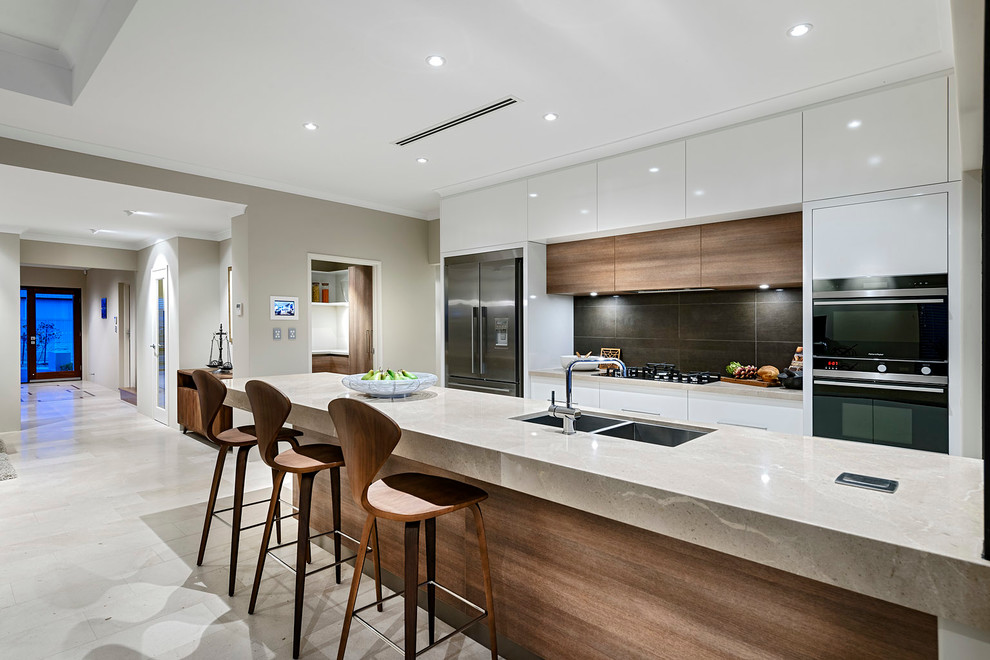 Photo of a contemporary galley kitchen in Perth with a double-bowl sink, flat-panel cabinets, white cabinets, black splashback, stainless steel appliances and with island.