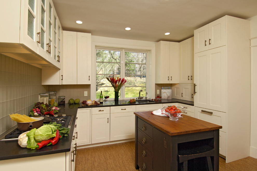 Mid-sized transitional u-shaped light wood floor and beige floor eat-in kitchen photo in DC Metro with an undermount sink, shaker cabinets, white cabinets, granite countertops, green backsplash, glass tile backsplash, white appliances and an island