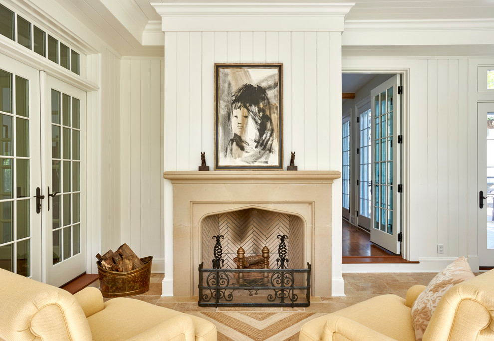 Inspiration for a mid-sized traditional enclosed family room in New York with a music area, white walls, limestone floors, a standard fireplace, a stone fireplace surround and beige floor.