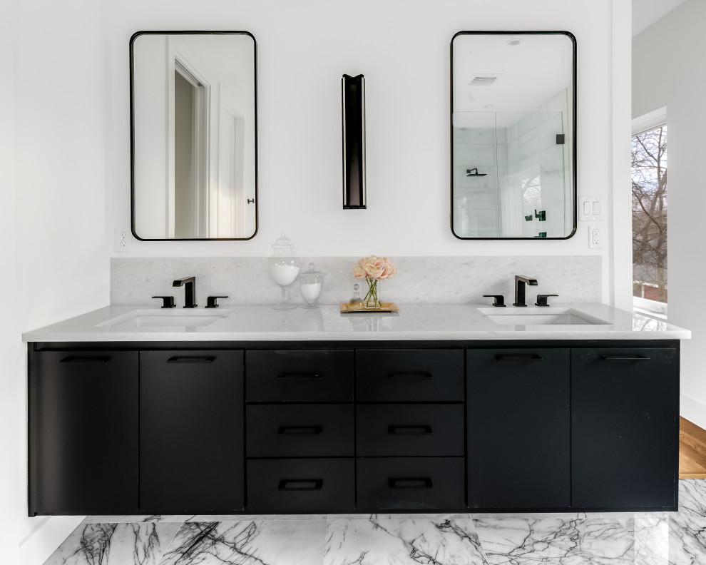 Inspiration for a large contemporary ensuite bathroom in Dallas with flat-panel cabinets, white cabinets, a submerged bath, a two-piece toilet, white tiles, marble tiles, white walls, marble flooring, a submerged sink, marble worktops, black floors, a hinged door, white worktops, an enclosed toilet, double sinks and a floating vanity unit.