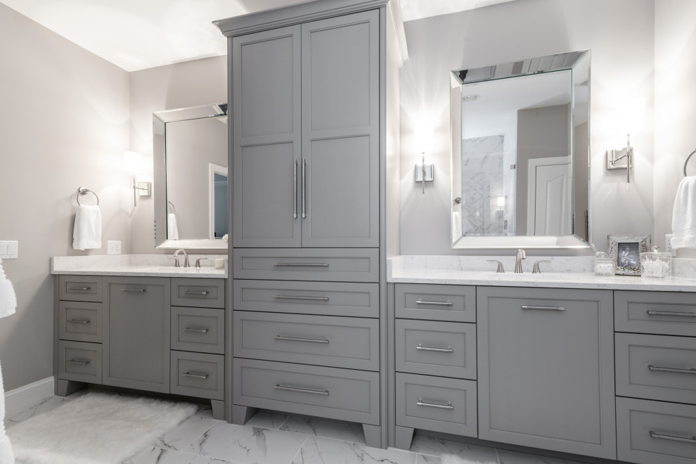 This is an example of a mid-sized transitional master bathroom in Charlotte with shaker cabinets, grey cabinets, white tile, porcelain tile, grey walls, porcelain floors, an undermount sink, engineered quartz benchtops, white floor, white benchtops, a shower seat, a double vanity and a built-in vanity.