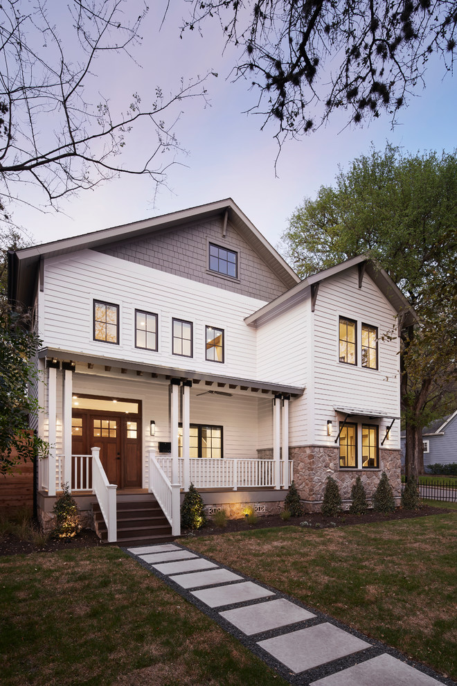 This is an example of a transitional two-storey exterior in Austin with mixed siding, a gable roof and a shingle roof.