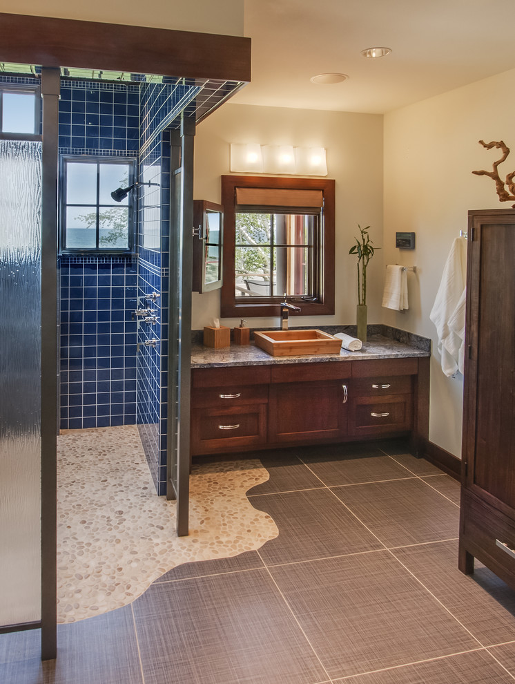 Photo of a country bathroom in Milwaukee with a curbless shower and pebble tile floors.