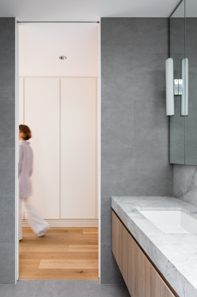 Photo of a large contemporary bathroom in Sydney with light wood cabinets, an undermount sink, granite benchtops, an open shower, a double vanity and a built-in vanity.