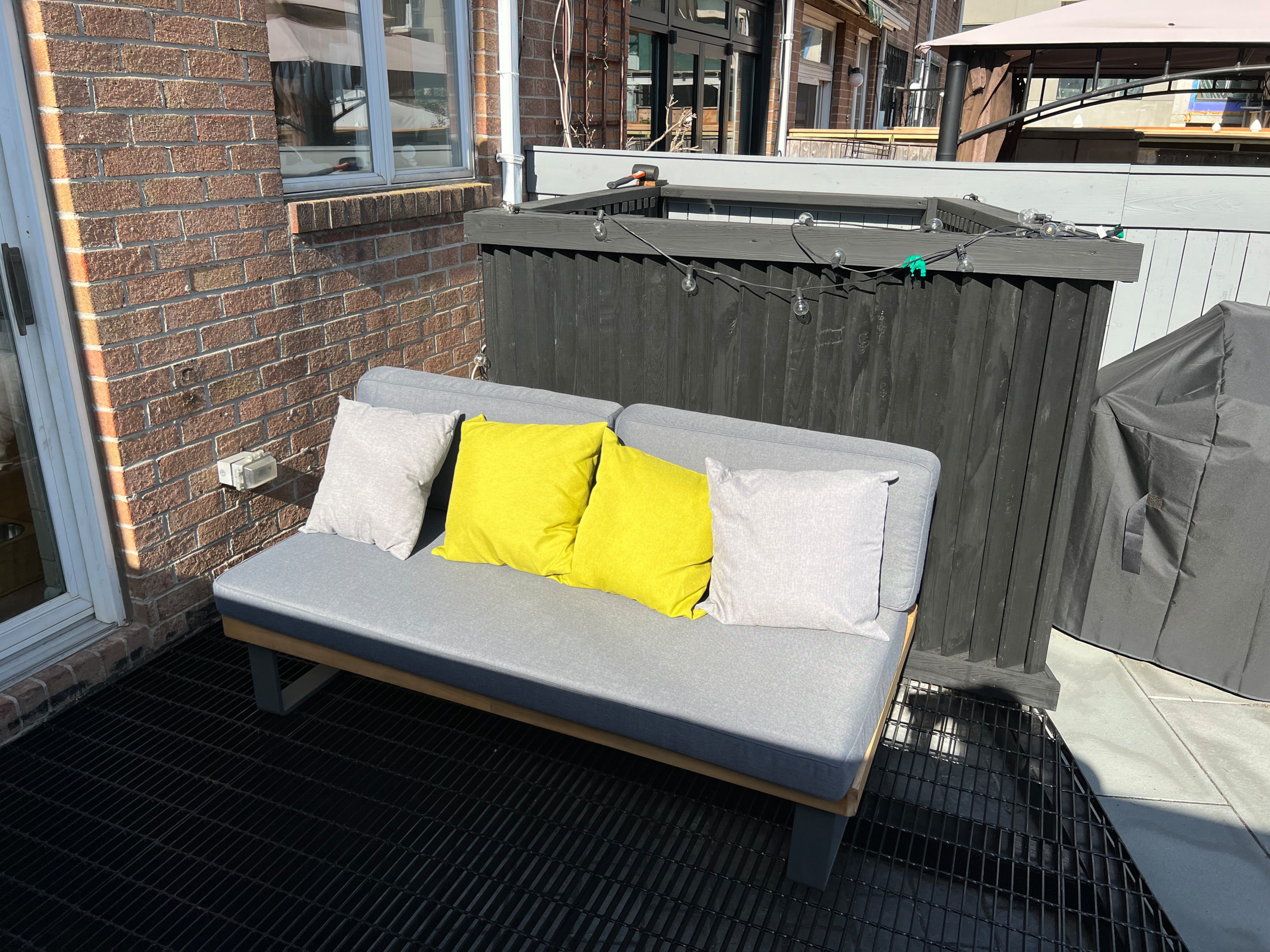 Paved patio with metal grating garden