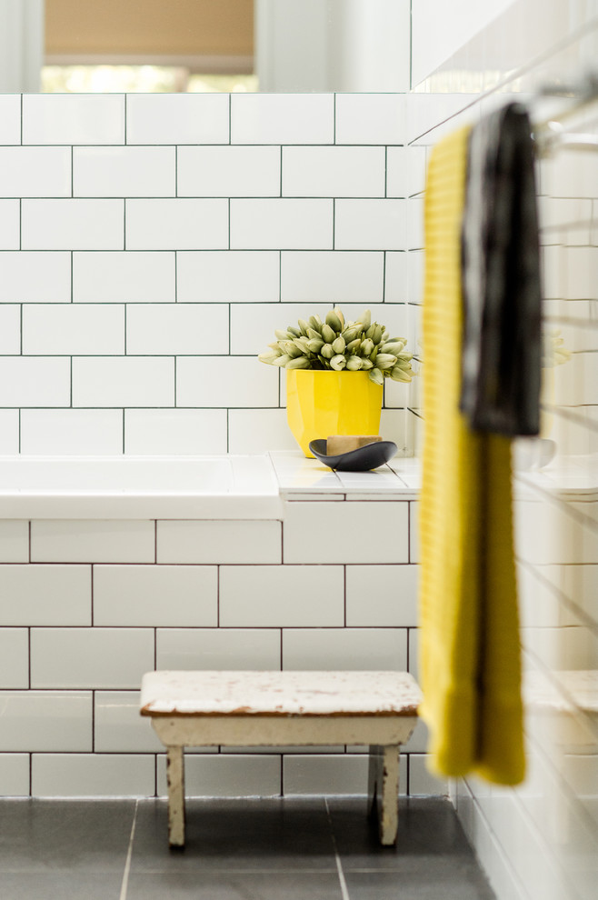 This is an example of a mid-sized scandinavian master bathroom in Canberra - Queanbeyan with white cabinets, a drop-in tub, an open shower, a one-piece toilet, white tile, subway tile, white walls, ceramic floors, a wall-mount sink and granite benchtops.