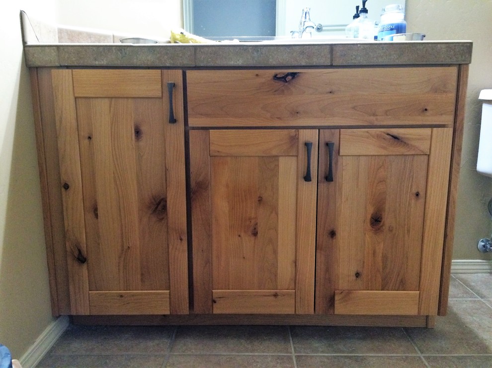 Example of a mid-sized mountain style 3/4 bathroom design in Phoenix with shaker cabinets, light wood cabinets and tile countertops