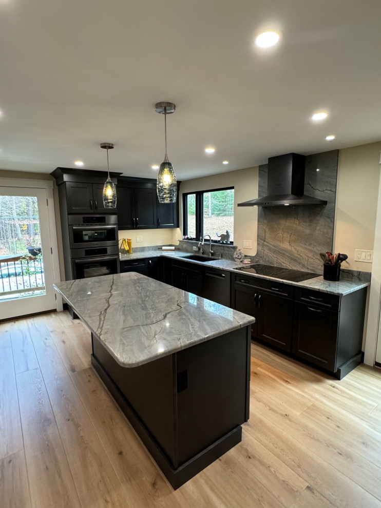 Mid-sized transitional u-shaped laminate floor and brown floor eat-in kitchen photo in Boston with an undermount sink, shaker cabinets, brown cabinets, quartz countertops, black appliances, an island and multicolored countertops