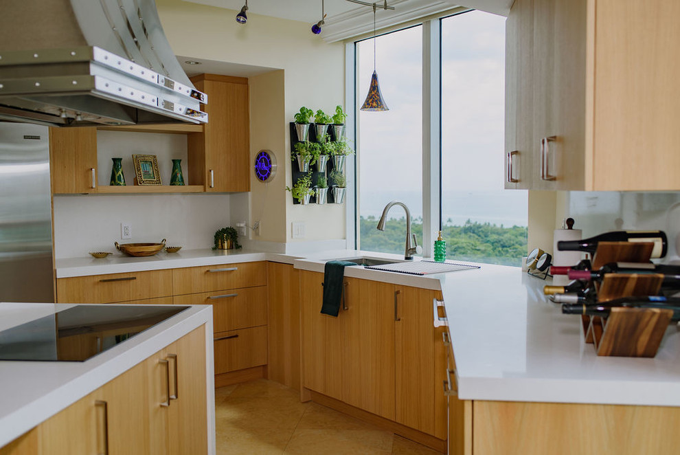 Inspiration for a mid-sized transitional u-shaped porcelain tile open concept kitchen remodel in Miami with an undermount sink, flat-panel cabinets, light wood cabinets, quartz countertops, white backsplash, stainless steel appliances, an island and white countertops