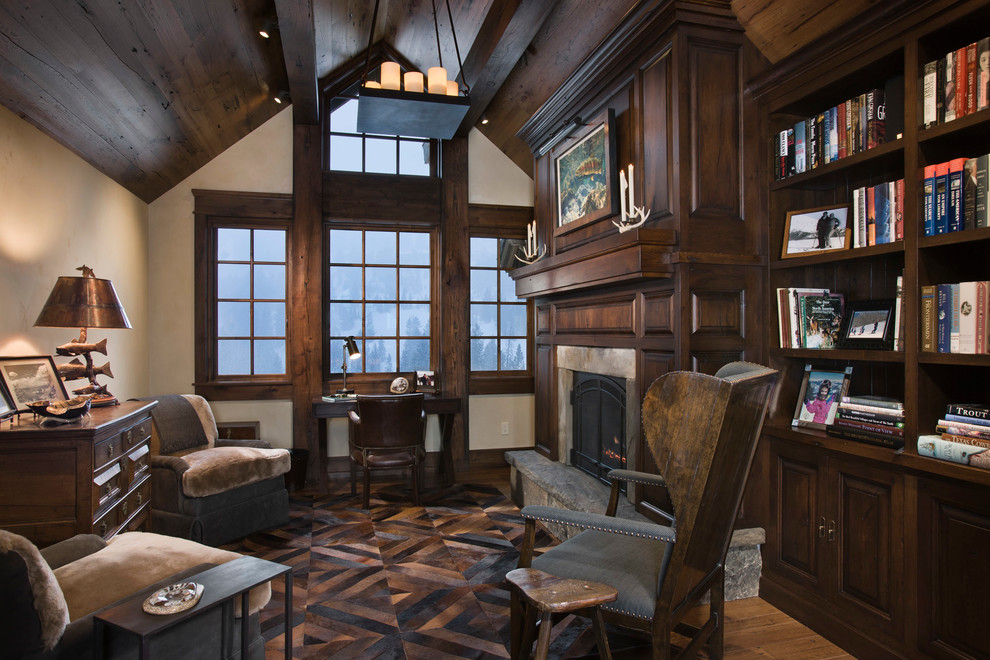 This is an example of a country home office in Other with beige walls, medium hardwood floors and a freestanding desk.