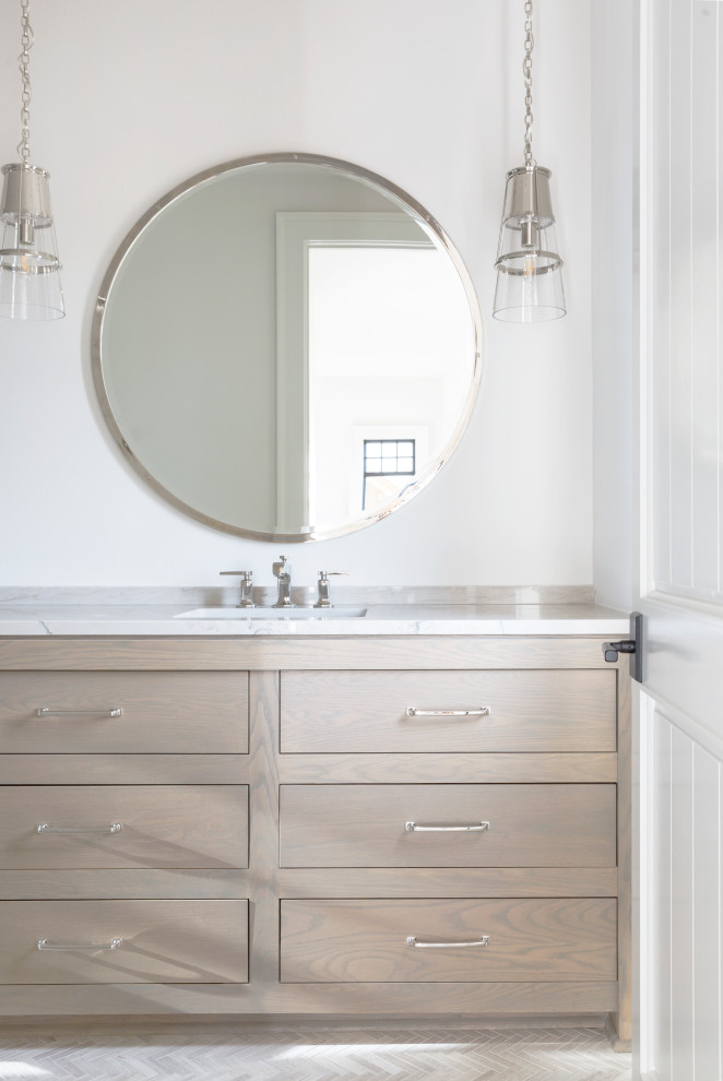 This is an example of a large transitional kids bathroom in Milwaukee with furniture-like cabinets, light wood cabinets, white walls, travertine floors, an undermount sink, quartzite benchtops, beige floor, a hinged shower door and grey benchtops.